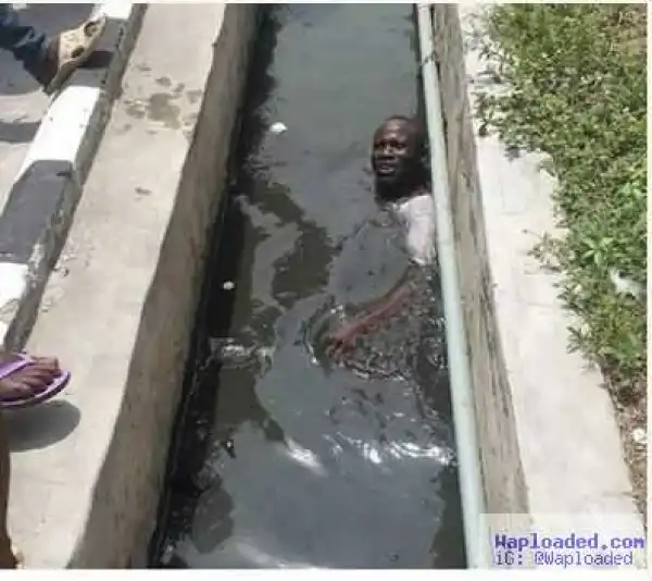 Man Swims in Lagos Gutter after Smooking Weed (Photo)